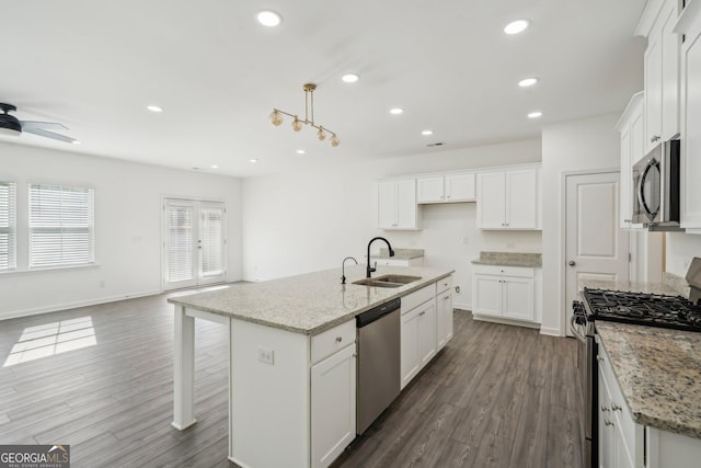 2946 Stockholm Way, Suwanee, GA 30024 - kitchen with recessed lighting, white cabinets, dark wood-style floors, a sink, and appliances with stainless steel finishes