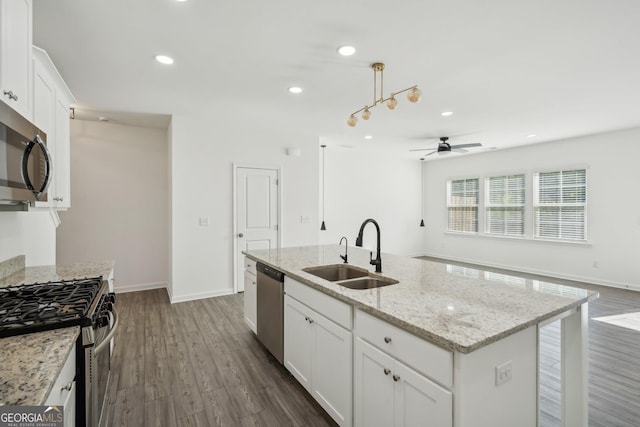 2946 Stockholm Way, Suwanee, GA 30024 - kitchen featuring a sink, dark wood-style flooring, ceiling fan, an island with sink, and appliances with stainless steel finishes