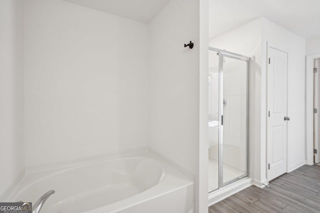 2946 Stockholm Way, Suwanee, GA 30024 - bathroom featuring a garden tub, wood finished floors, and a shower stall