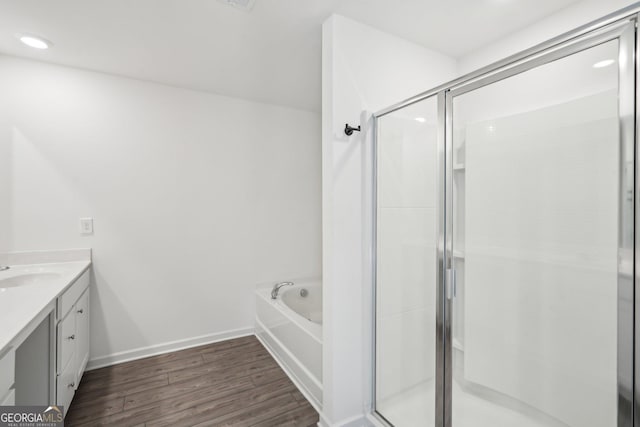 2946 Stockholm Way, Suwanee, GA 30024 - bathroom featuring a bath, a shower stall, vanity, and wood finished floors