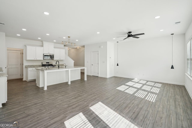 2946 Stockholm Way, Suwanee, GA 30024 - unfurnished living room featuring baseboards, wood finished floors, recessed lighting, and ceiling fan