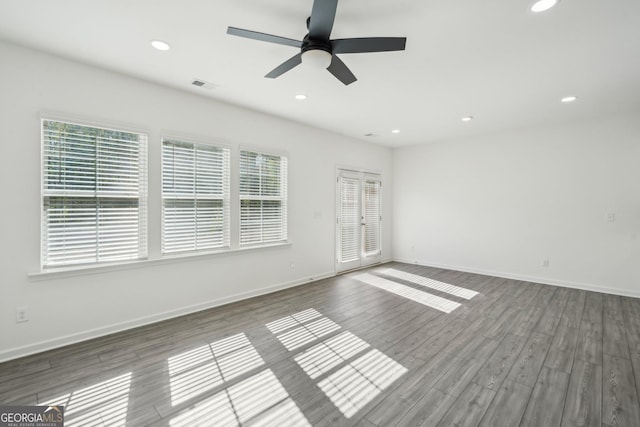 2946 Stockholm Way, Suwanee, GA 30024 - unfurnished room featuring wood finished floors, visible vents, and a healthy amount of sunlight