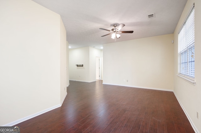 548 W Oaks Dr, Woodstock, GA 30188 - unfurnished room featuring dark wood finished floors, visible vents, a ceiling fan, and baseboards
