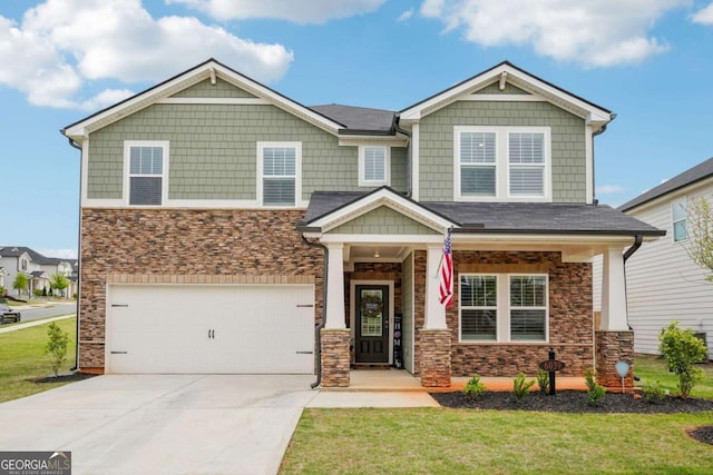 craftsman inspired home featuring concrete driveway, an attached garage, stone siding, and a front lawn