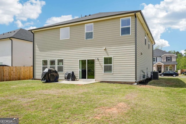 rear view of house with a yard, fence, and a patio area