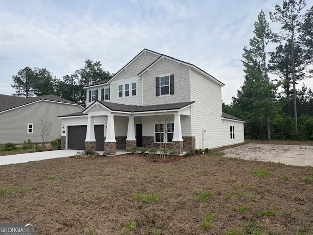 211 Park View Ln, Kingsland, GA 31548 - craftsman inspired home with stone siding, driveway, a porch, a garage, and a front lawn