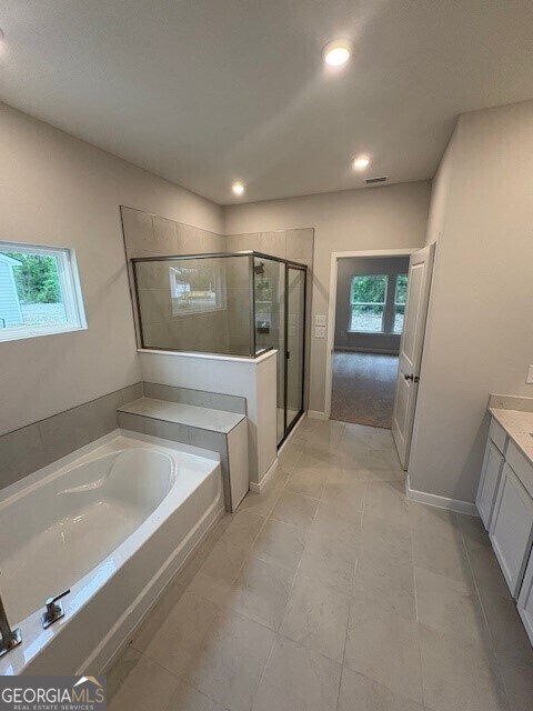 211 Park View Ln, Kingsland, GA 31548 - bathroom featuring healthy amount of natural light, a garden tub, a shower stall, recessed lighting, and vanity