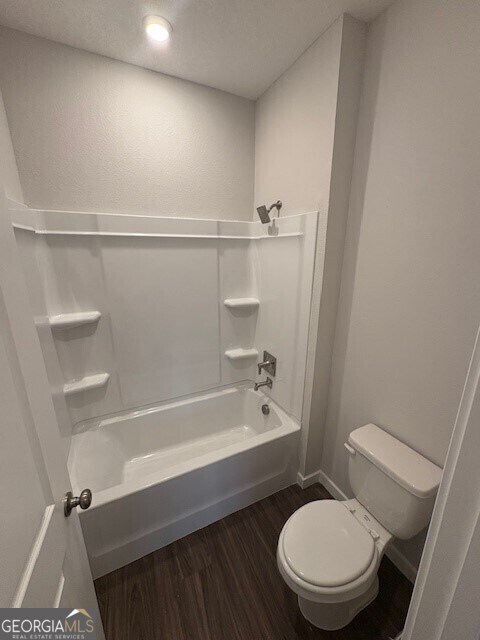 211 Park View Ln, Kingsland, GA 31548 - bathroom with wood finished floors, toilet, and bathtub / shower combination