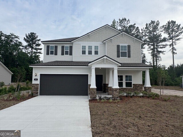 211 Park View Ln, Kingsland, GA 31548 - craftsman inspired home with an attached garage, driveway, stone siding, and a porch