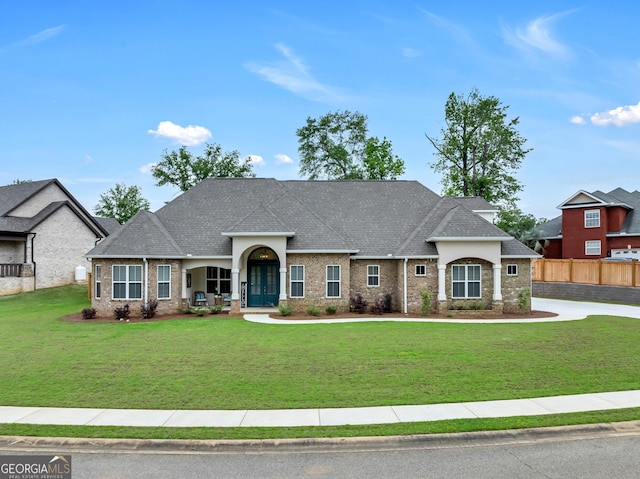 303 Wilsons Creek Bnd, Bonaire, GA 31005 - craftsman inspired home featuring brick siding, fence, a front lawn, and roof with shingles