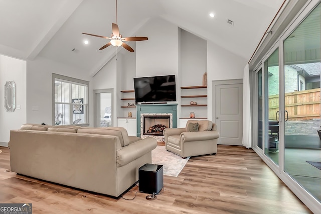 303 Wilsons Creek Bnd, Bonaire, GA 31005 - living room with high vaulted ceiling, ceiling fan, light wood-style floors, and a fireplace