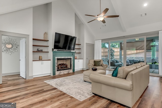 303 Wilsons Creek Bnd, Bonaire, GA 31005 - living room with light wood-style flooring, ceiling fan, a fireplace, visible vents, and high vaulted ceiling