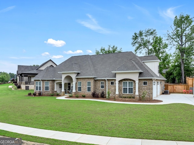 303 Wilsons Creek Bnd, Bonaire, GA 31005 - view of front facade with a front yard, driveway, brick siding, and fence