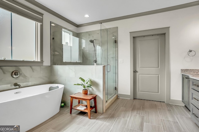 303 Wilsons Creek Bnd, Bonaire, GA 31005 - bathroom with recessed lighting, vanity, a freestanding tub, a stall shower, and baseboards