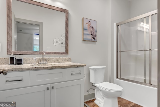 303 Wilsons Creek Bnd, Bonaire, GA 31005 - full bath featuring baseboards, enclosed tub / shower combo, toilet, wood finished floors, and vanity