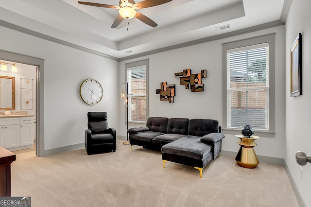 303 Wilsons Creek Bnd, Bonaire, GA 31005 - living room with baseboards, light carpet, ceiling fan, and a tray ceiling