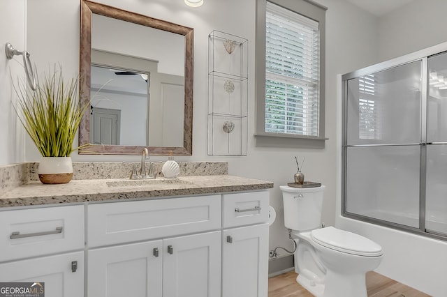 303 Wilsons Creek Bnd, Bonaire, GA 31005 - bathroom with shower / bath combination with glass door, vanity, toilet, baseboards, and wood finished floors