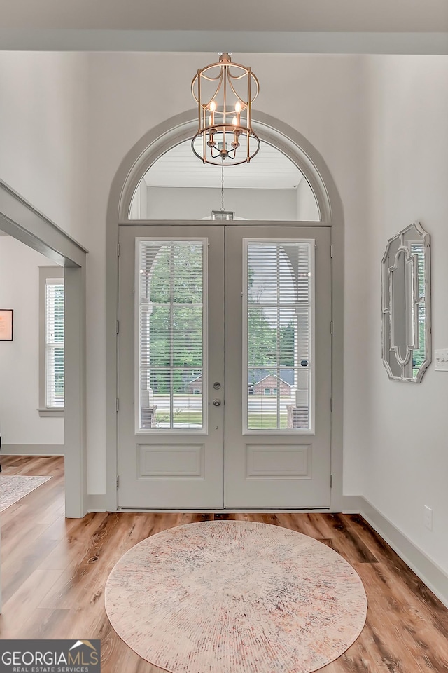 303 Wilsons Creek Bnd, Bonaire, GA 31005 - doorway to outside with wood finished floors, a notable chandelier, and french doors