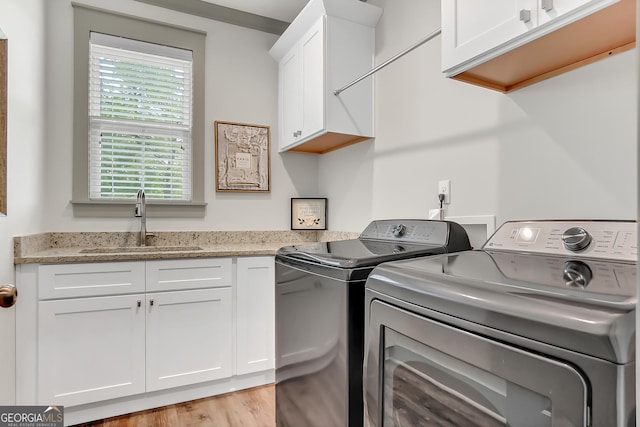 303 Wilsons Creek Bnd, Bonaire, GA 31005 - laundry room featuring washer and dryer, a sink, cabinet space, and light wood-style floors