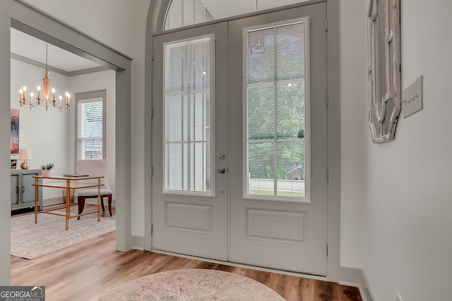 303 Wilsons Creek Bnd, Bonaire, GA 31005 - doorway to outside with wood finished floors, french doors, and a notable chandelier