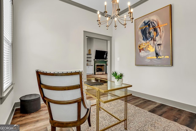 303 Wilsons Creek Bnd, Bonaire, GA 31005 - dining area featuring a fireplace, wood finished floors, a chandelier, and baseboards