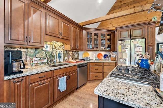 511 Oakdale Rd, Canton, GA 30114 - kitchen with lofted ceiling, light wood finished floors, a sink, decorative backsplash, and appliances with stainless steel finishes