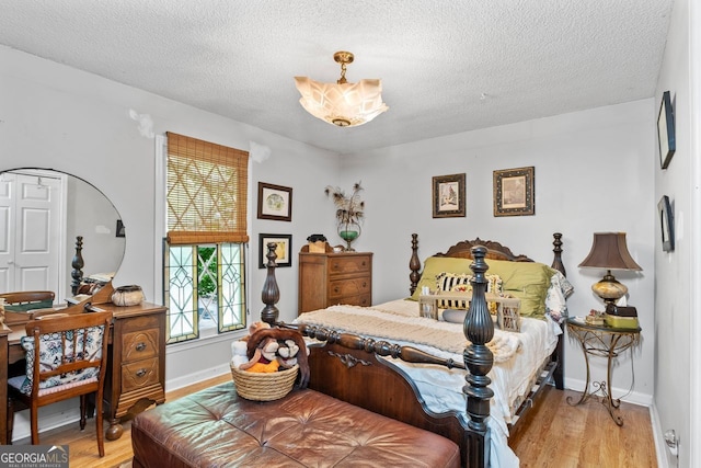 511 Oakdale Rd, Canton, GA 30114 - bedroom with multiple windows, light wood-style floors, and a textured ceiling