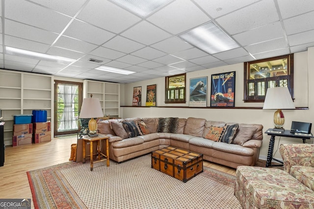 511 Oakdale Rd, Canton, GA 30114 - living room with built in shelves, a drop ceiling, visible vents, and wood finished floors