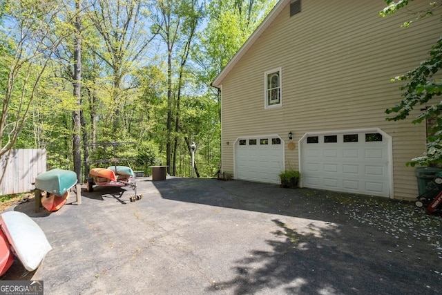 511 Oakdale Rd, Canton, GA 30114 - view of side of home featuring an attached garage and driveway