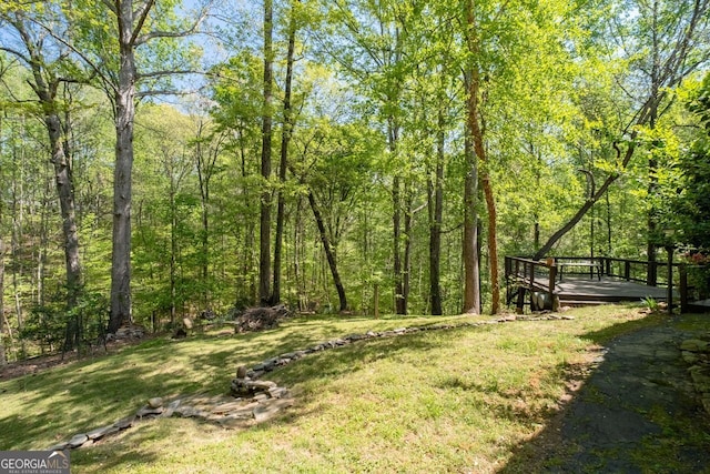 511 Oakdale Rd, Canton, GA 30114 - view of yard with a deck and a view of trees