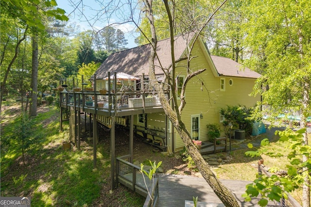 511 Oakdale Rd, Canton, GA 30114 - back of house featuring central AC unit, a wooden deck, and a shingled roof
