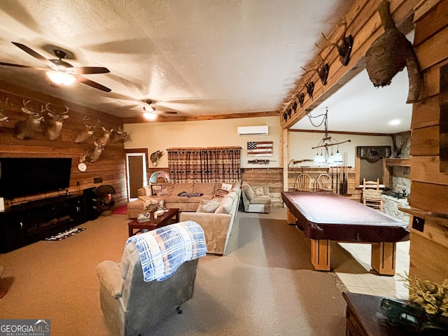 recreation room featuring a fireplace, ceiling fan, a wall mounted AC, and wooden walls