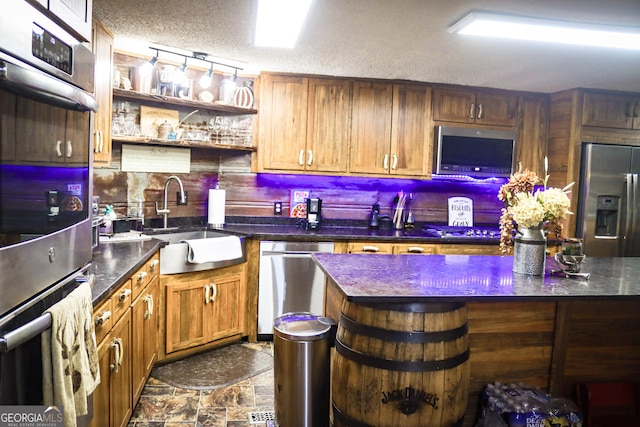 5524 Hooker Branch Rd, Millen, GA 30442 - bar area with appliances with stainless steel finishes, a sink, dark stone finish flooring, decorative backsplash, and a textured ceiling