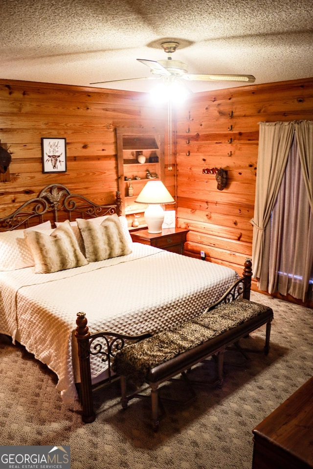 5524 Hooker Branch Rd, Millen, GA 30442 - carpeted bedroom with wood walls, a textured ceiling, and a ceiling fan
