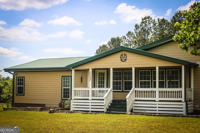 5524 Hooker Branch Rd, Millen, GA 30442 - view of front of house with a porch, a front yard, and metal roof