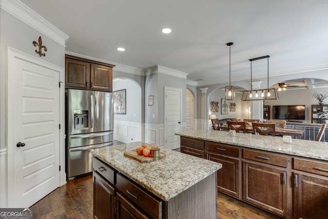 3097 Trinity Grove Dr, Dacula, GA 30019 - kitchen with ornamental molding, stainless steel fridge, arched walkways, and a kitchen island