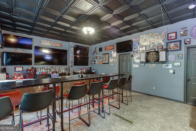3097 Trinity Grove Dr, Dacula, GA 30019 - bar featuring baseboards, a dry bar, an ornate ceiling, tile patterned floors, and a notable chandelier