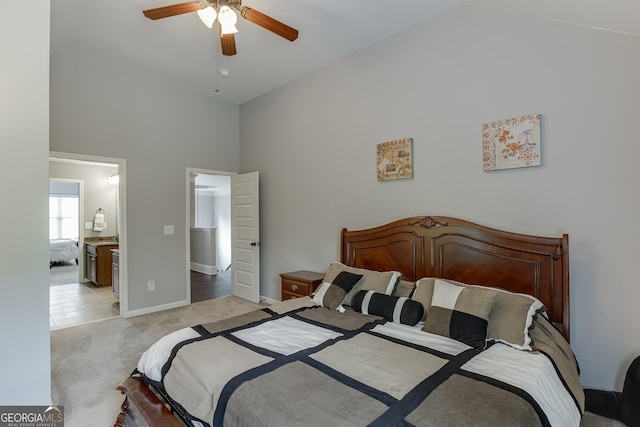 3097 Trinity Grove Dr, Dacula, GA 30019 - bedroom featuring connected bathroom, high vaulted ceiling, a ceiling fan, baseboards, and light colored carpet
