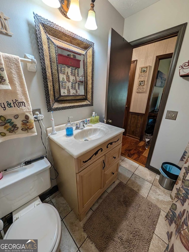 bathroom featuring vanity, toilet, and tile patterned floors