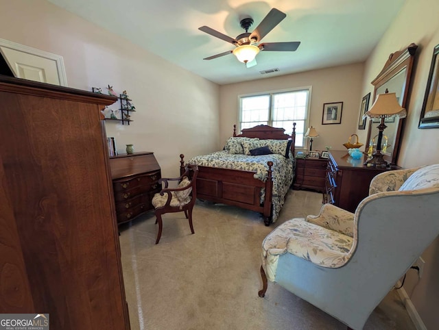 bedroom with visible vents, ceiling fan, and light carpet