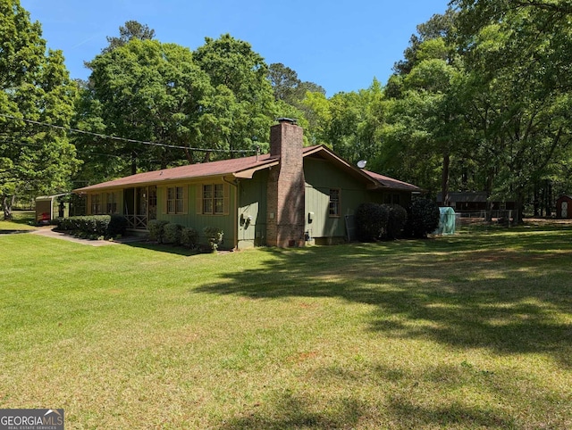 view of property exterior with a lawn and a chimney