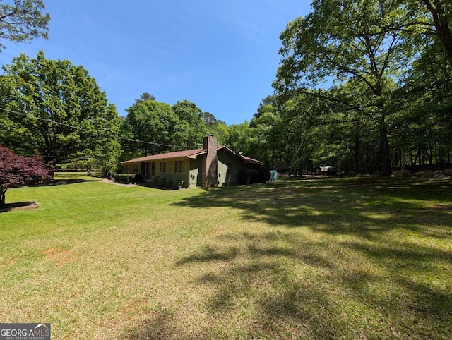 view of yard with a wooded view