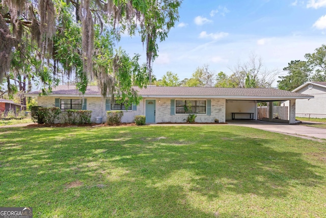 705 Oak Ln, Brunswick, GA 31523 - ranch-style home with an attached carport, a front yard, driveway, and brick siding