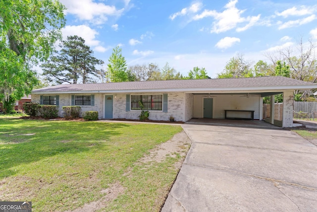 705 Oak Ln, Brunswick, GA 31523 - ranch-style home featuring a carport, concrete driveway, and brick siding