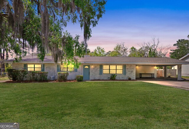 705 Oak Ln, Brunswick, GA 31523 - ranch-style home featuring a carport, concrete driveway, and brick siding