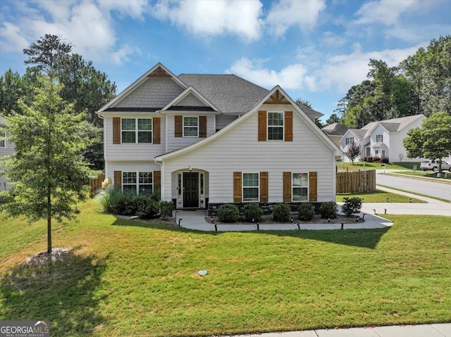 view of front of house featuring a front yard and fence
