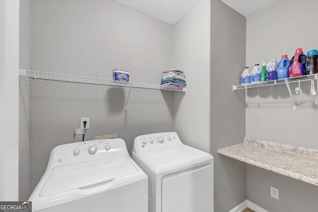 clothes washing area with washer and clothes dryer and laundry area