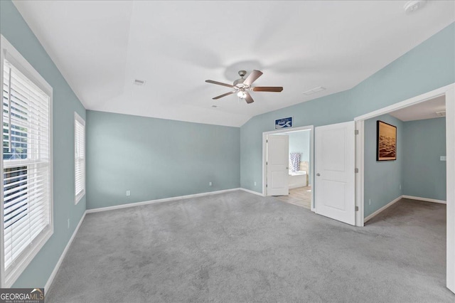 unfurnished bedroom featuring carpet floors, visible vents, a ceiling fan, and baseboards