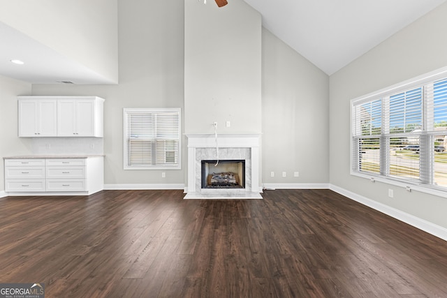 517 Lago Ct, Lagrange, GA 30241 - unfurnished living room with a premium fireplace, baseboards, dark wood-style floors, and high vaulted ceiling