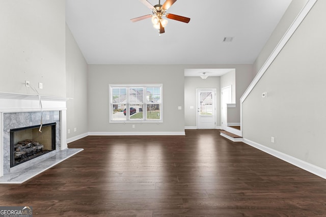 517 Lago Ct, Lagrange, GA 30241 - unfurnished living room featuring ceiling fan, visible vents, baseboards, a fireplace, and dark wood-style flooring